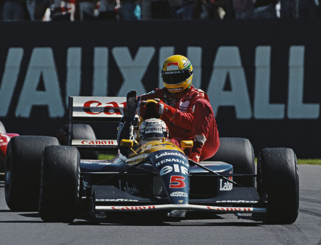 Ayrton Senna riding on top of Nigel Mansell's FW14 after the 1991 British Grand Prix